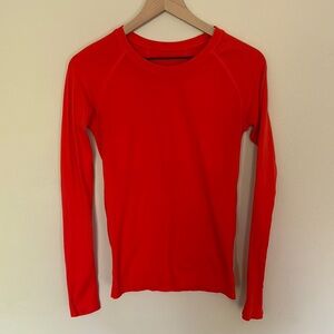 Athleta orange-red long-sleeve athletic top